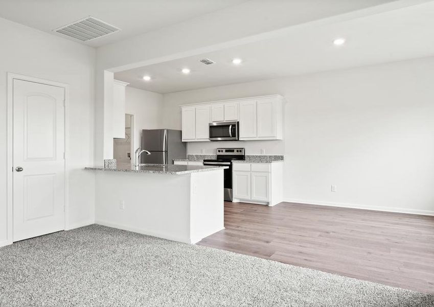 The kitchen of the Cypress has beautiful white wood cabinets.