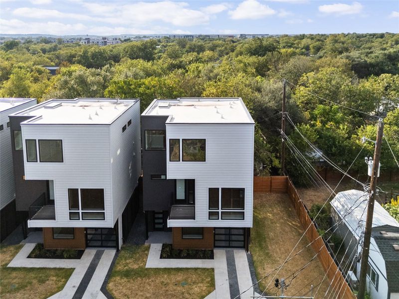 Striking contemporary lines define these multi-level modern residences nestled alongside mature trees.