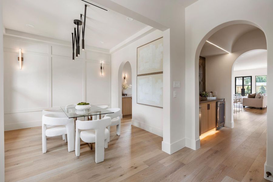 Alternate view upon entry boasting 12-ft ceilings and sculpted archways, connecting to the dry bar and butler's pantry Alternate view upon entry boasting 12-ft ceilings and sculpted archways, connecting to the dry bar and butler's pantry
