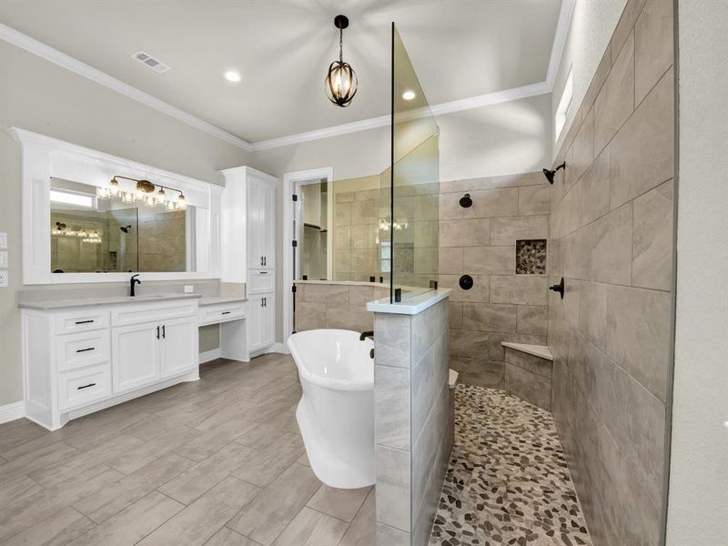 Bathroom with crown molding, vanity, and separate shower and tub