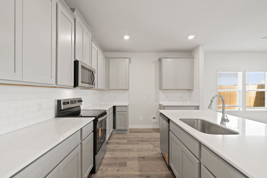 A kitchen with white cabinets. A kitchen with white cabinets.