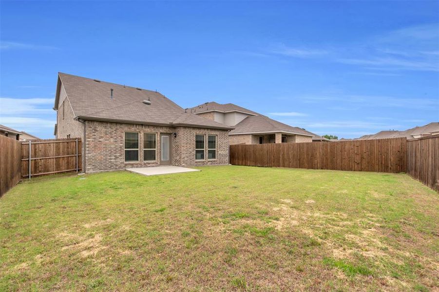 Rear view of property featuring a patio, roof with shingles, and brick siding Rear view of property featuring a patio, roof with shingles, and brick siding