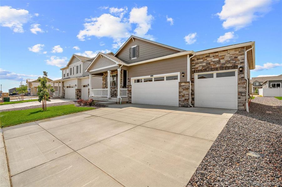 Front exterior of a new home in Lakeside Canyon, Mead, CO, highlighting curb appeal (Image 15). Front exterior of a new home in Lakeside Canyon, Mead, CO, highlighting curb appeal (Image 15).