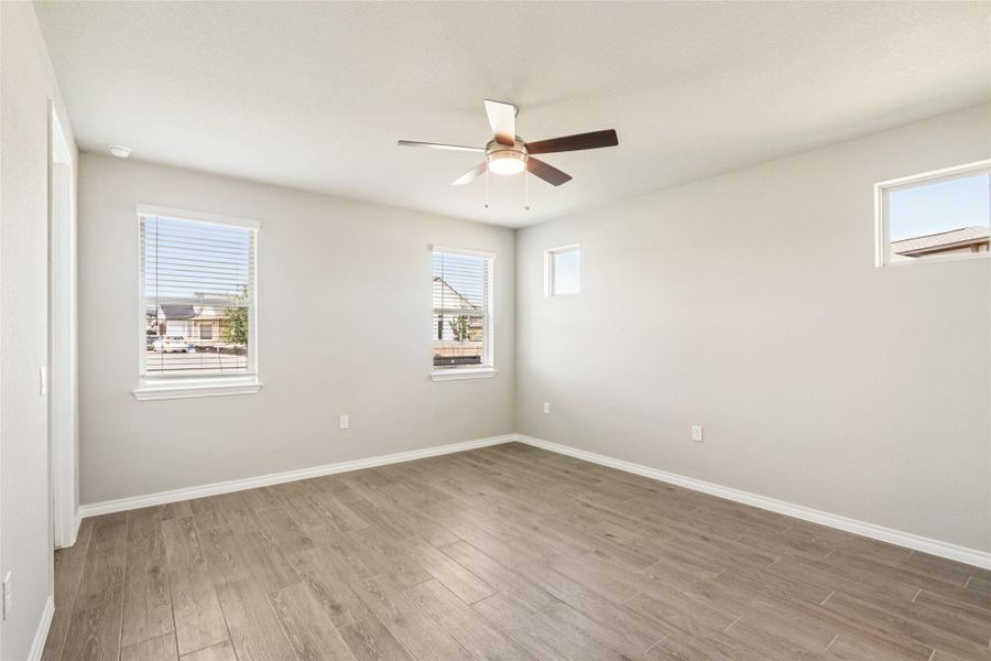 Empty room featuring wood finished floors and ceiling fan