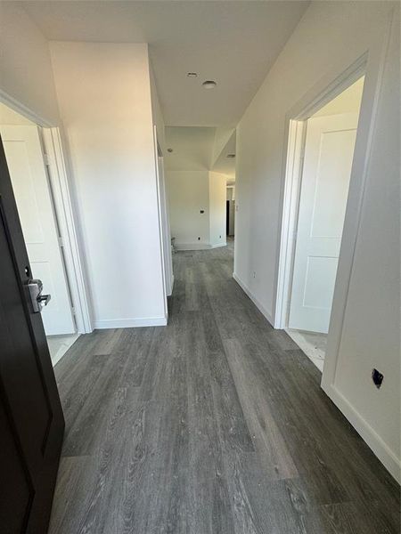 Hall featuring dark wood-type flooring