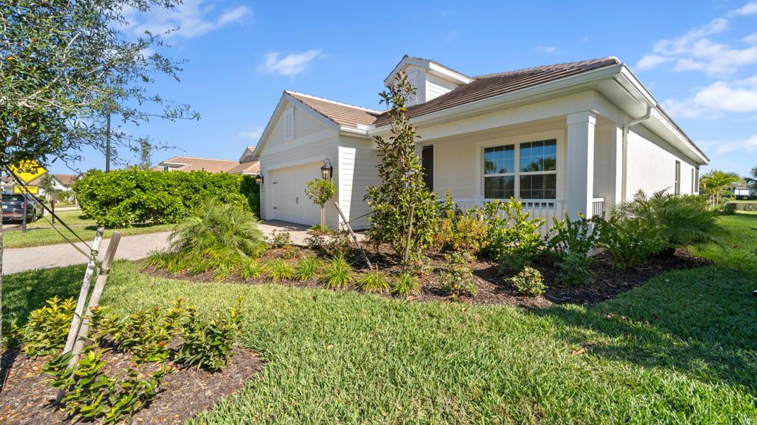 Front exterior of a new home in Verandah, Fort Myers, FL, highlighting curb appeal (Image 18).