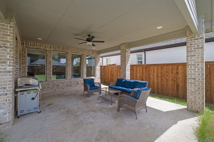 View of patio / terrace with fence, an outdoor hangout area, a ceiling fan, and area for grilling