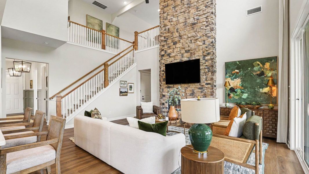 Gathering room with high ceilings and stone fireplace