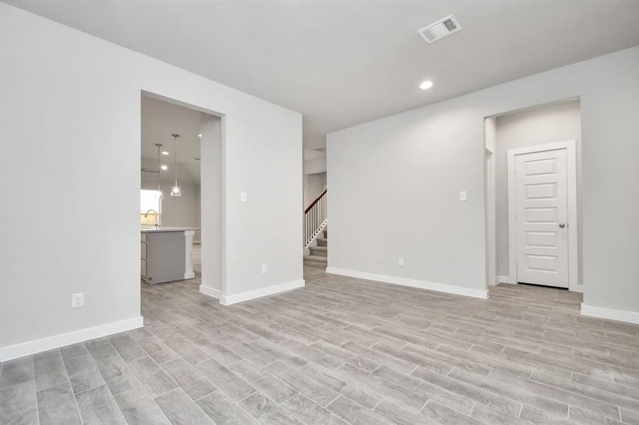 Make memories gathered around the table with your family and friends in this dining room. Features elegant flooring, custom paint, and adjacent to kitchen for convenience & open concept feel. Sample photo of completed home with similar floor plan. As-built interior colors and selections may vary.