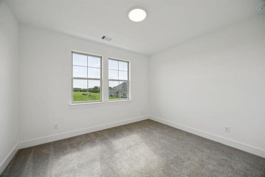 Spare room featuring carpet floors and baseboards Spare room featuring carpet floors and baseboards