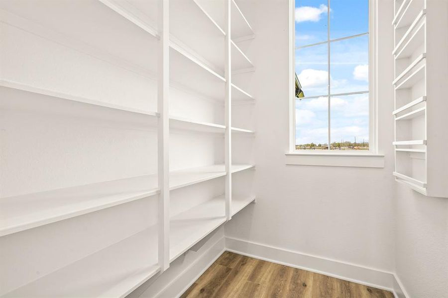 This spacious, walk-in Pantry boasts floor-to-ceiling shelving and a built-in spice rack. This is also a great place to store large appliances, leaving more room in the Kitchen for frequently used items. Staying organized just got easier!