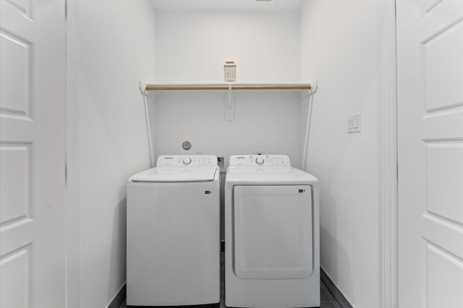 Conveniently located on the second floor, this well-appointed laundry room offers easy access from nearby bedrooms—streamlining daily routines and eliminating the need to carry laundry up and down stairs.