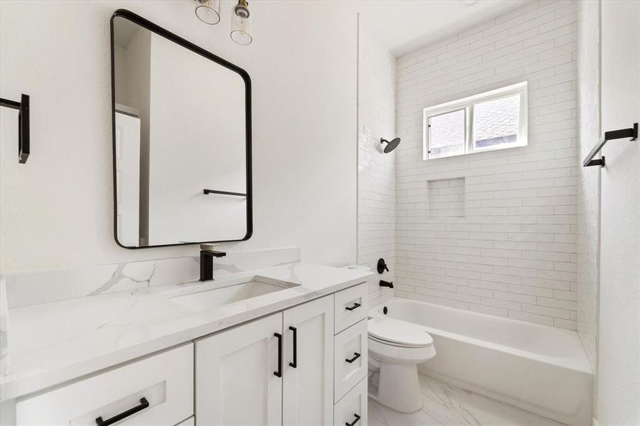 The full bathroom offers crisp white tile flooring, a spacious vanity, and a luxurious quartz countertop. Enjoy the convenience of a shower-tub combo, perfect for both quick showers and relaxing baths.