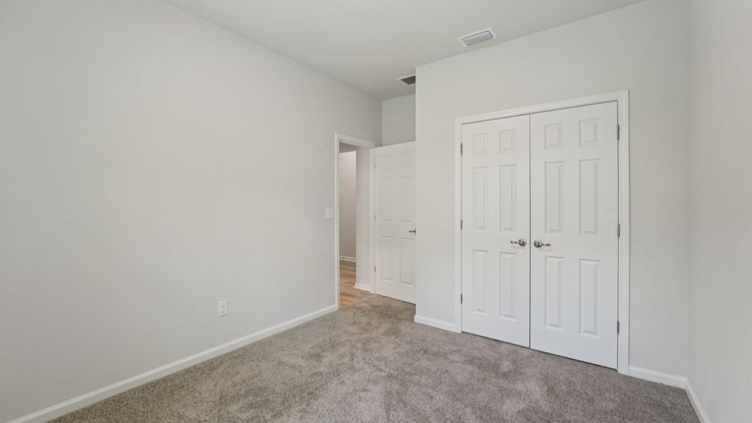 Luxurious plush carpeting and pristine white double doors define style in Palm Coast's Landmark floor plan.