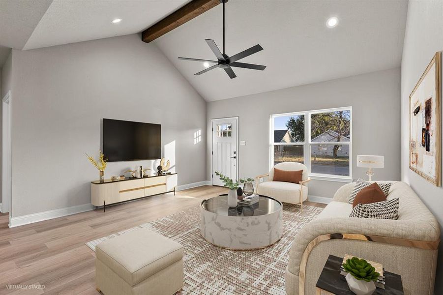 Living area featuring light wood-type flooring, high vaulted ceiling, beamed ceiling, recessed lighting, and ceiling fan Living area featuring light wood-type flooring, high vaulted ceiling, beamed ceiling, recessed lighting, and ceiling fan