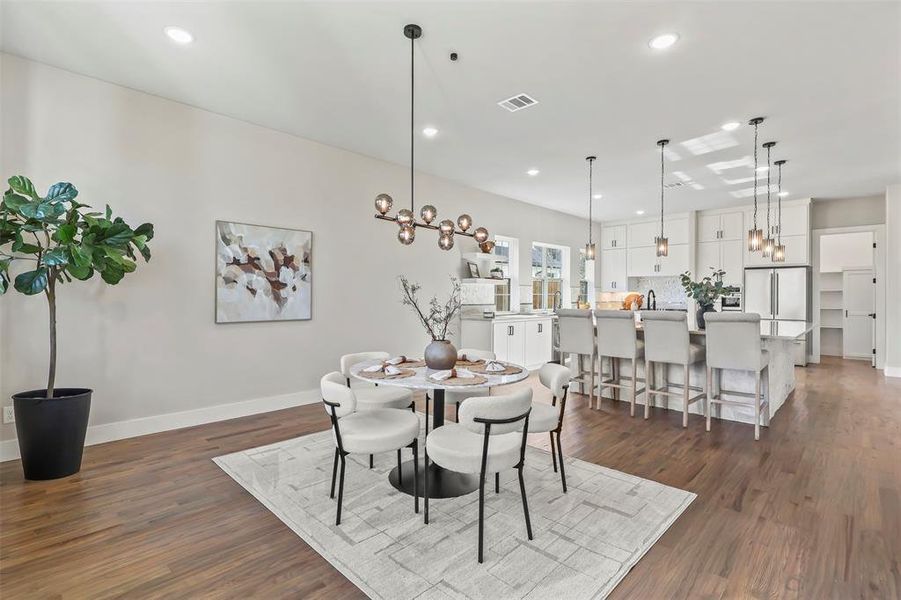 Dining area featuring a chandelier, dark wood-style floors, and recessed lighting Dining area featuring a chandelier, dark wood-style floors, and recessed lighting