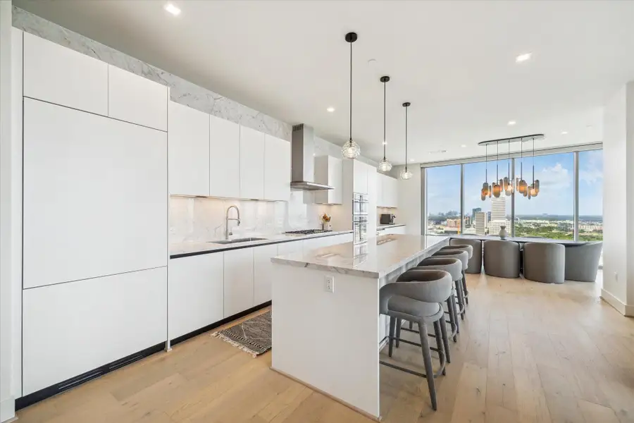 Looking west out the window, views go on for miles and lighting designed by Nina Magon is spectacular over the dining room table.