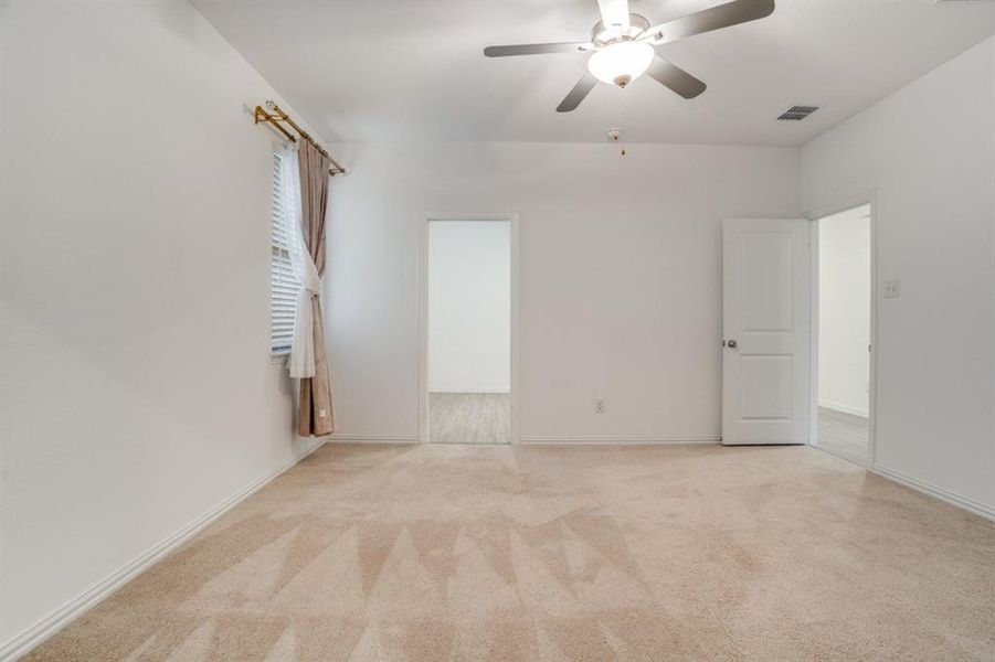 Spare room featuring ceiling fan and light colored carpet