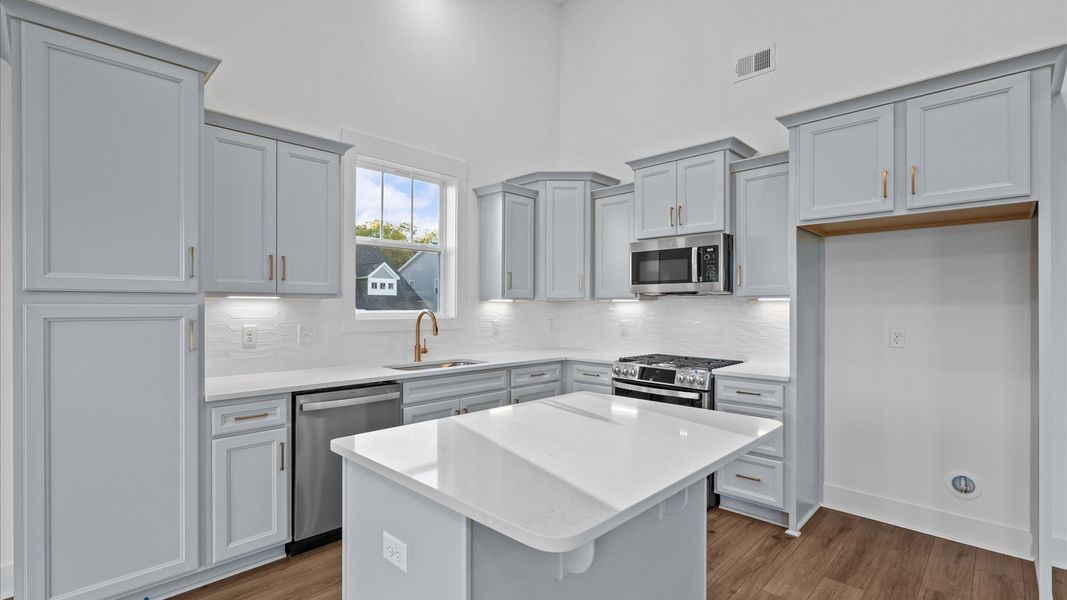 Vibrant kitchen layout with a center island, refined finishes, and open-concept flow