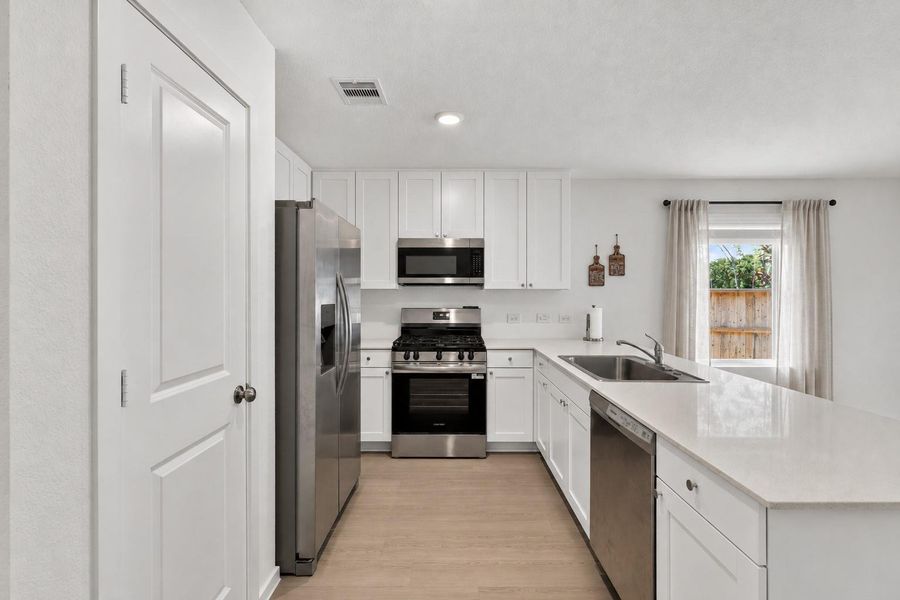 Conveniently designed spaces continue throughout the main level, making everyday living feel effortless.