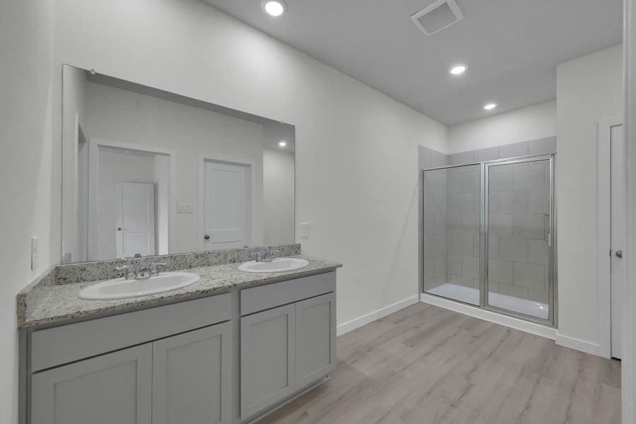 Primary bathroom featuring dual vanities, ample counter space, and updated vanity/fixtures Primary bathroom featuring dual vanities, ample counter space, and updated vanity/fixtures