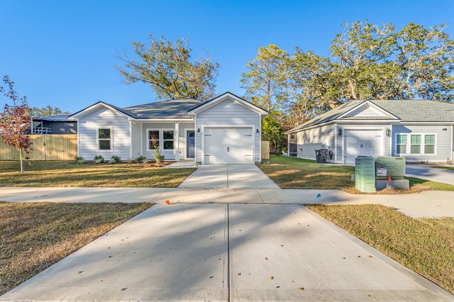 Front exterior of a new home in Live Oak Cottages, Freeport, FL, highlighting curb appeal (Image 2). Front exterior of a new home in Live Oak Cottages, Freeport, FL, highlighting curb appeal (Image 2).