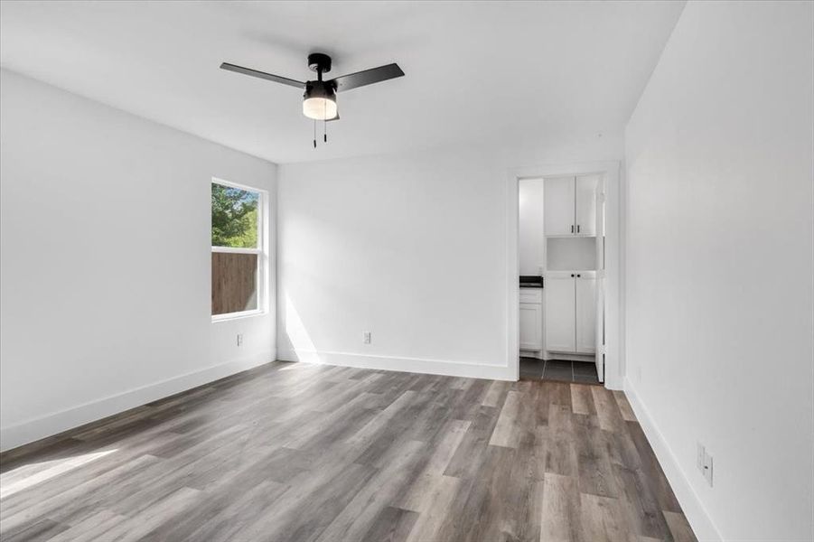 Unfurnished room with ceiling fan and light wood-type flooring