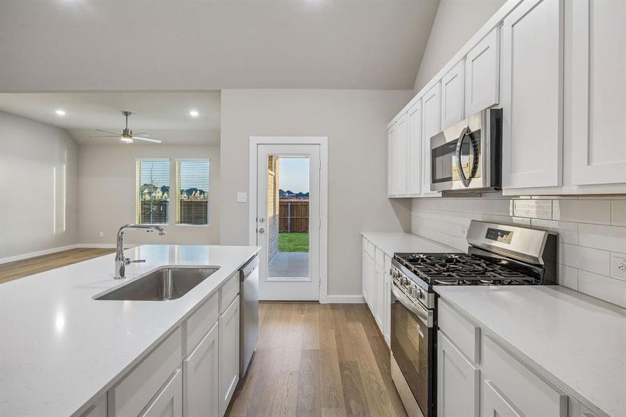 Kitchen in the Wimbledon home plan by Trophy Signature Homes – REPRESENTATIVE PHOTO
