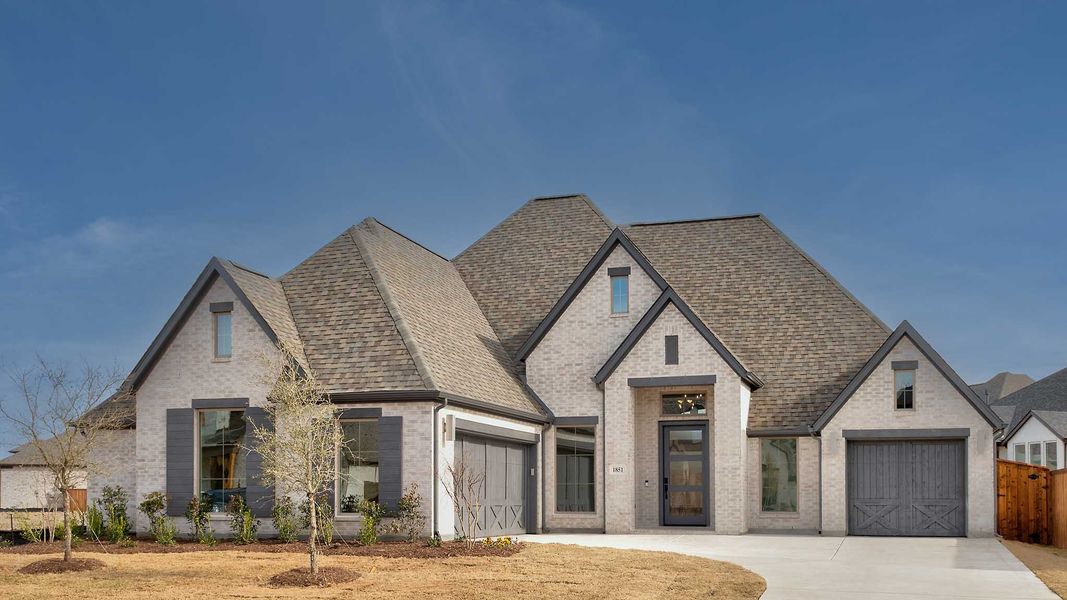 Front exterior of a new home in Sonoma Verde, McLendon-Chisholm, TX, highlighting curb appeal (Image 1). Front exterior of a new home in Sonoma Verde, McLendon-Chisholm, TX, highlighting curb appeal (Image 1).