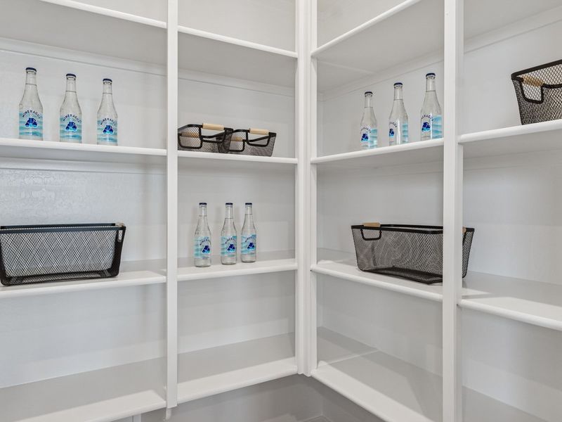 A white shelving unit with white shelves and baskets.