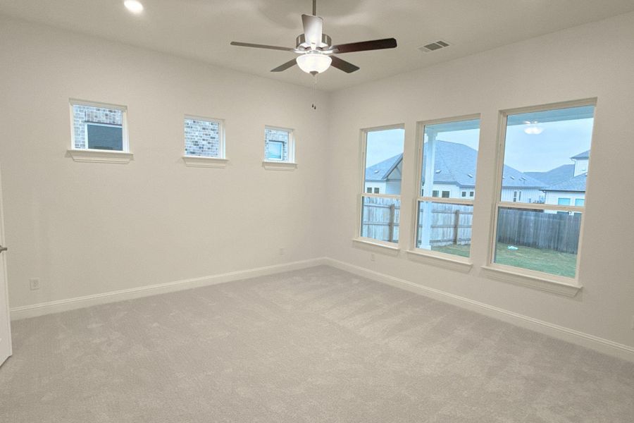 Spare room with carpet floors and a ceiling fan
