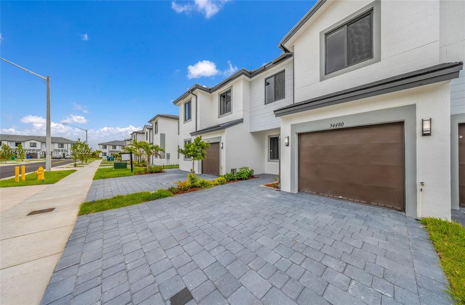 Front exterior of a new home in , Homestead, FL, highlighting curb appeal (Image 17).