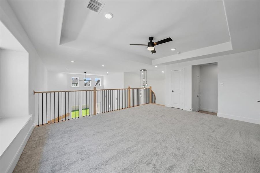 Spare room with recessed lighting, carpet flooring, a raised ceiling, and ceiling fan