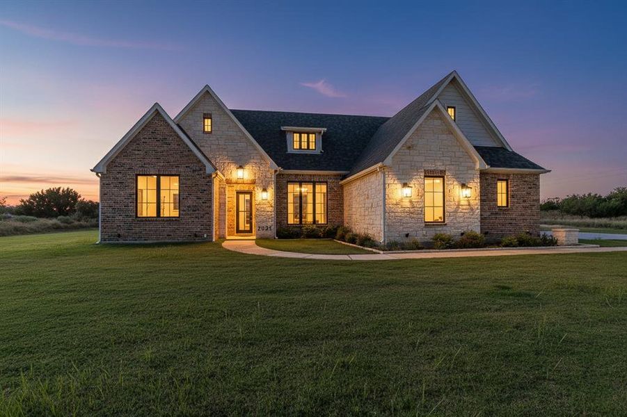 View of front of home with a front yard, stone siding, roof with shingles, and crawl space View of front of home with a front yard, stone siding, roof with shingles, and crawl space