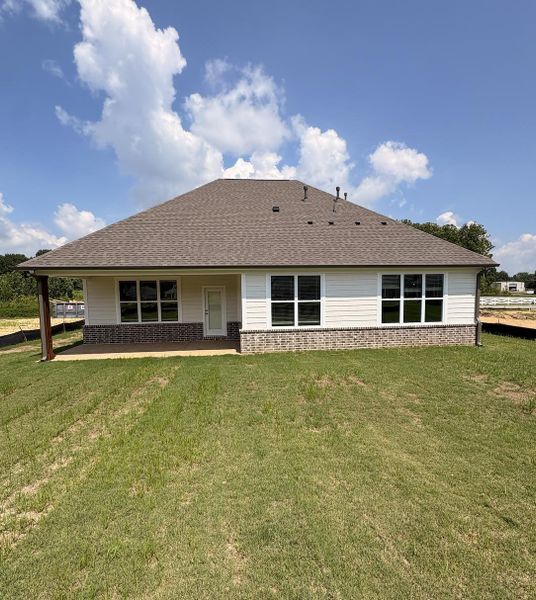 Rear exterior featuring a covered patio, extensive window placements, a combination of brick and siding finishes, and a shingled roof Rear exterior featuring a covered patio, extensive window placements, a combination of brick and siding finishes, and a shingled roof
