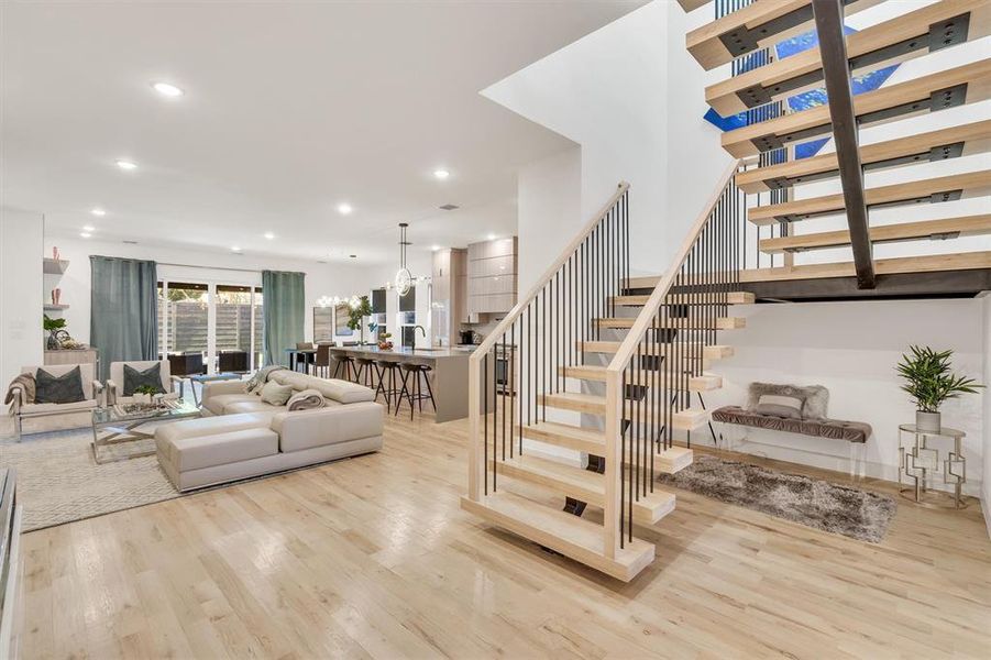 Staircase with an inviting chandelier and wood-type flooring