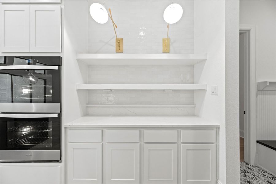 Stainless steel double ovens and butler pantry, ideal for serving or keeping kitchen essentials neatly tucked away.