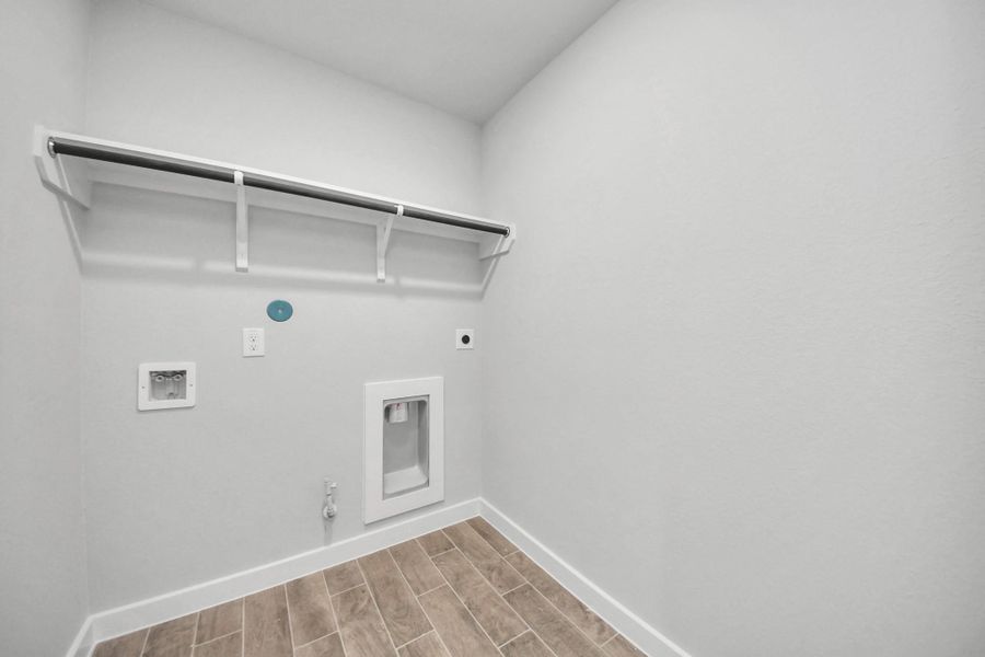 A perfect blend of functionality and comfort. Capture the essence of easy living with a first-floor laundry room, thoughtfully equipped with shelving for effortless organization. Both electric and gas connections available. Sample photo of completed home with similar floor plan. Actual colors and selections may vary. A perfect blend of functionality and comfort. Capture the essence of easy living with a first-floor laundry room, thoughtfully equipped with shelving for effortless organization. Both electric and gas connections available. Sample photo of completed home with similar floor plan. Actual colors and selections may vary.