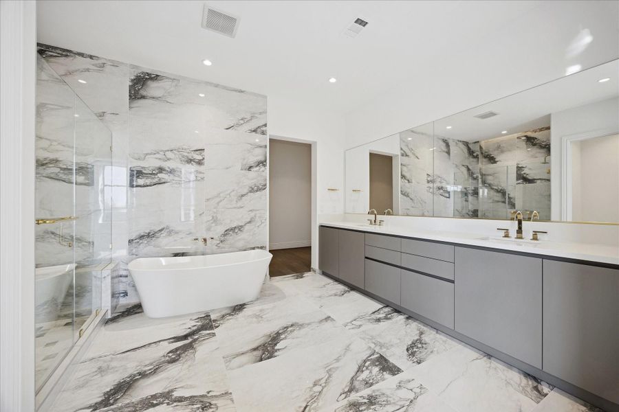 Bathrooms with oversized showers and frameless glass doors and high end fixtures Bathrooms with oversized showers and frameless glass doors and high end fixtures