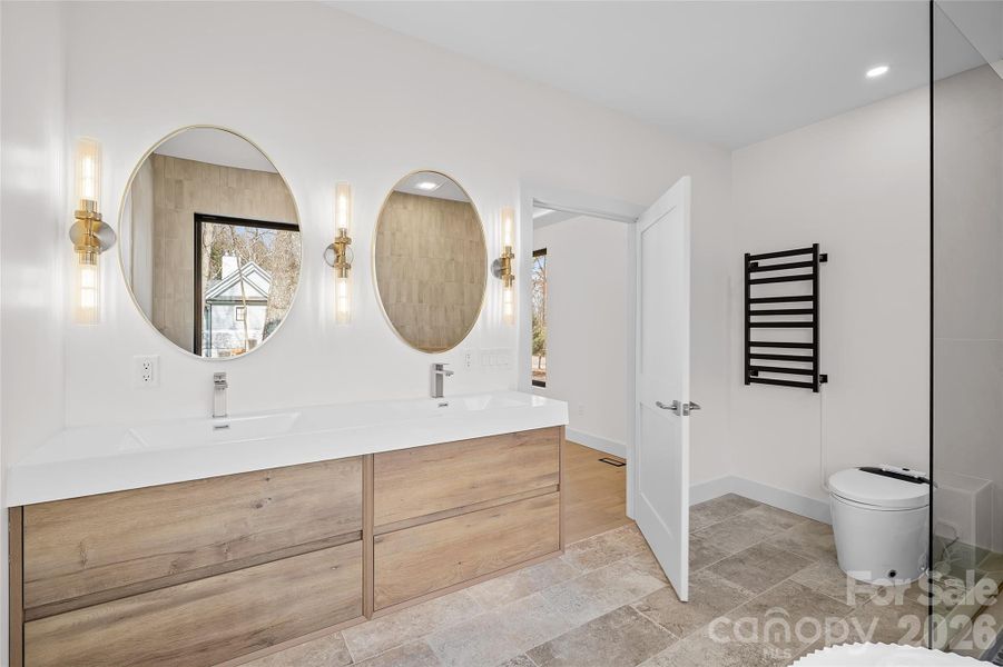 Floating vanity with integrated lighting, heated towel bar