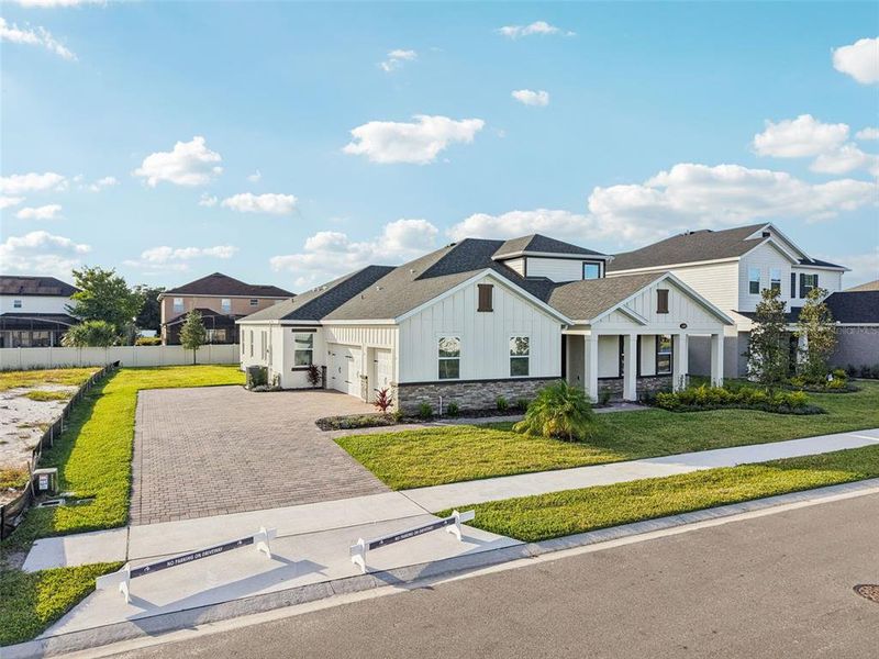 Front exterior of a new home in Hawk's Overlook, Oviedo, FL, highlighting curb appeal (Image 22).