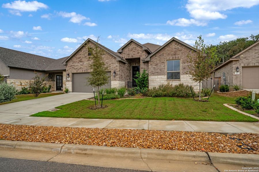 Front exterior of a new home in Cibolo Crossing, Universal City, TX, highlighting curb appeal (Image 1).