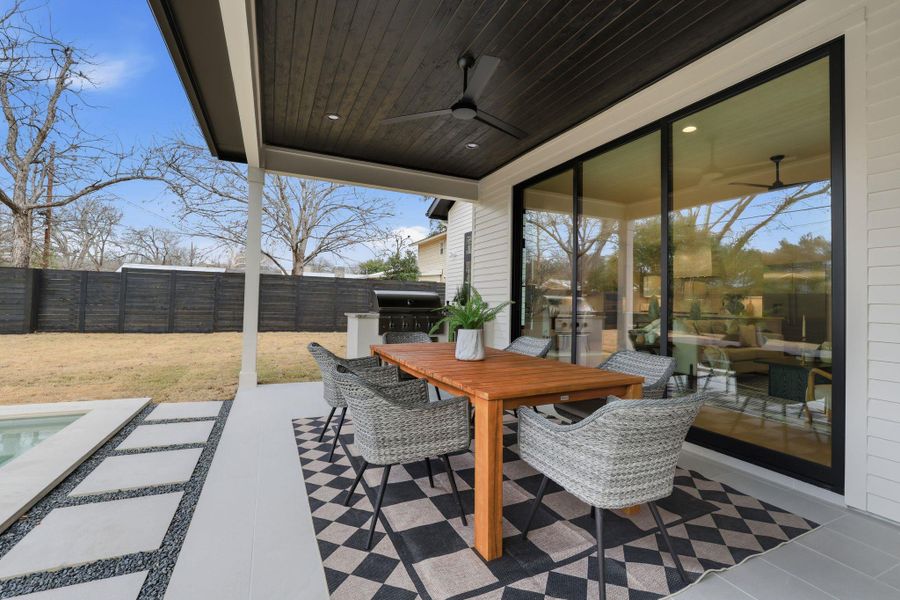 View of patio featuring outdoor dining area, a ceiling fan, and area for grilling