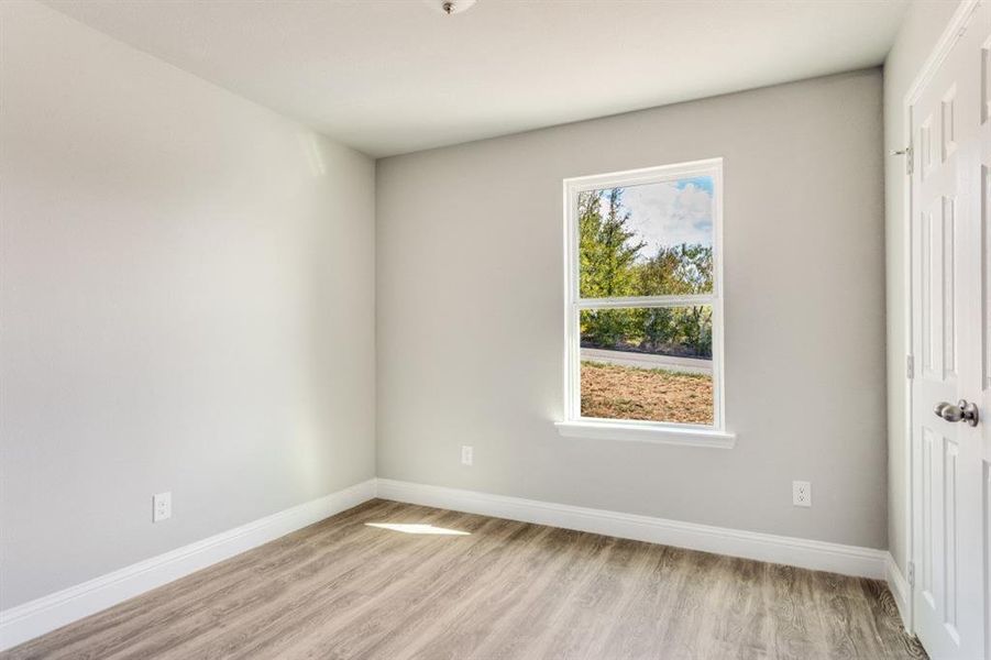 Unfurnished bedroom with light wood-style flooring and a closet