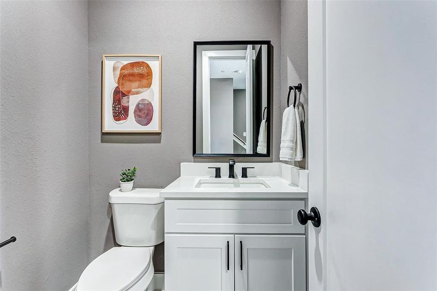 Chic guest bathroom with sleek white accents.