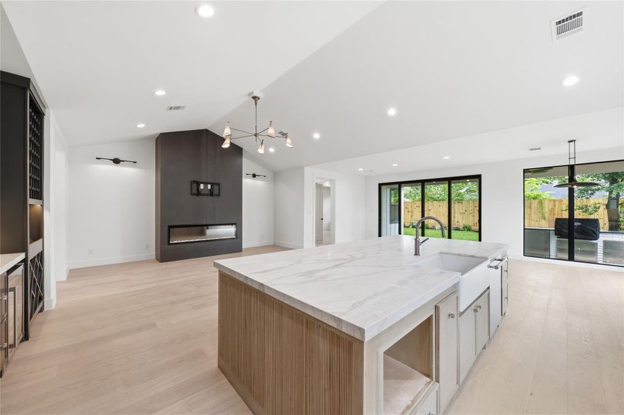 The expansive open-concept layout seamlessly connects the living, dining, and kitchen areas—perfect for both everyday living and entertaining.