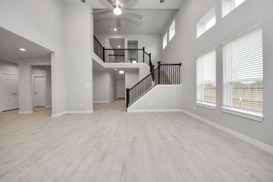 Relax and unwind in this inviting family room, illuminated by abundant naturallight streaming in through tall windows, complemented by high ceilings andstunning flooring. Sample photo of completed home with similar floor plan. Actual colors and selections may vary. Relax and unwind in this inviting family room, illuminated by abundant naturallight streaming in through tall windows, complemented by high ceilings andstunning flooring. Sample photo of completed home with similar floor plan. Actual colors and selections may vary.