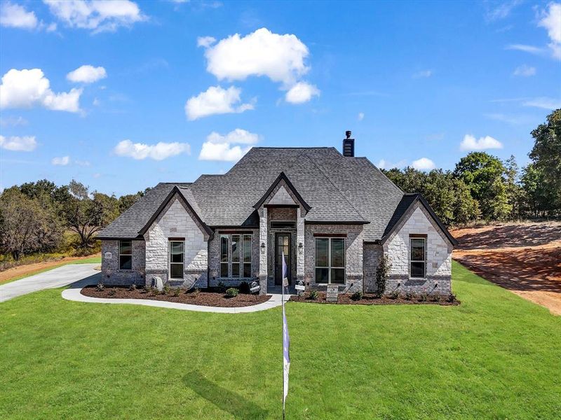 French country home with a front yard