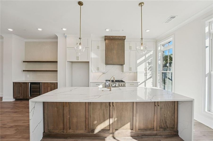 Kitchen storage- you need storage, we've got you covered!  Stacked tops and floating shelves, added cabinet shelving in oversized island- perfect storage for the seasonal items and entertaining pieces. Image is of a previously built Chamberlain Plan