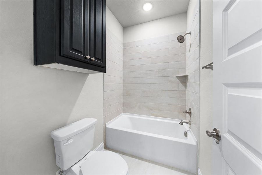 Bathroom with toilet and washtub / shower combination Bathroom with toilet and washtub / shower combination